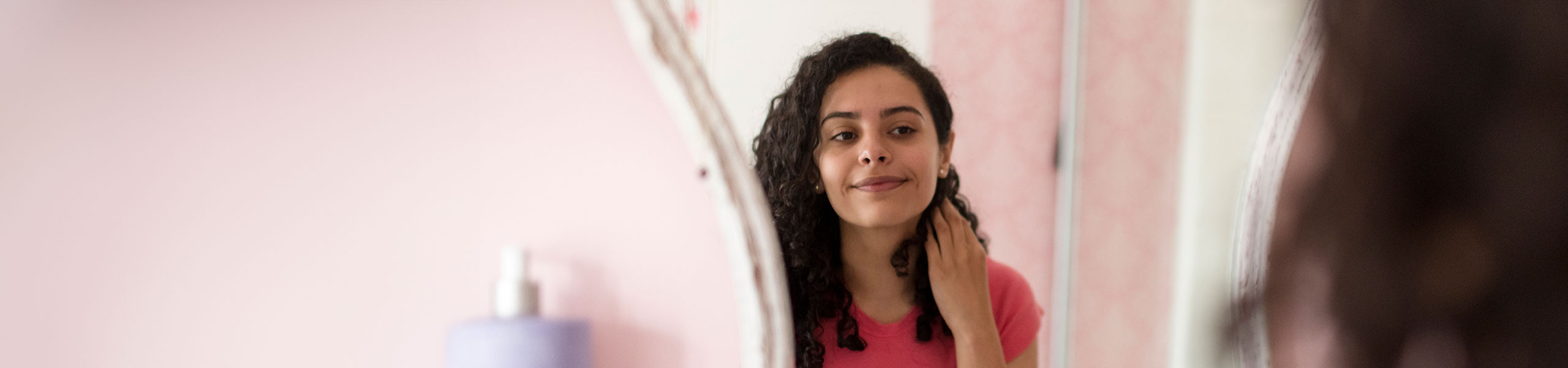 Teenage girl looking in a mirror