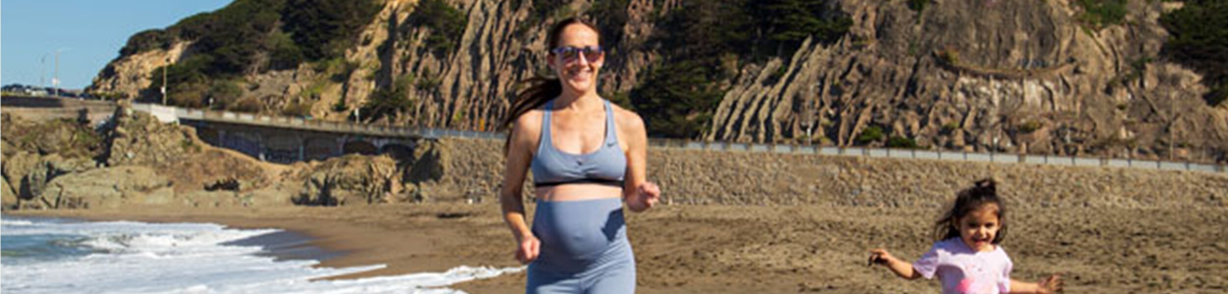 Olympian Shannon Rowbury running on the beach with her daughter