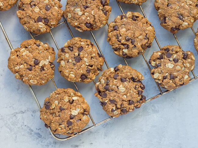 Chocolate chip oat date cookies cooling on a wire rack
