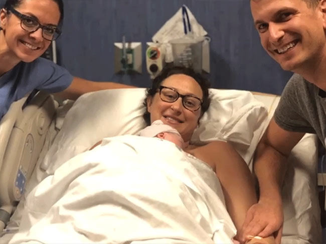 Stephanie Freeman with her husband and newborn baby.