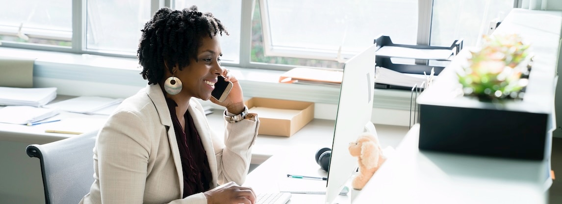 Lady smiling in front of computer