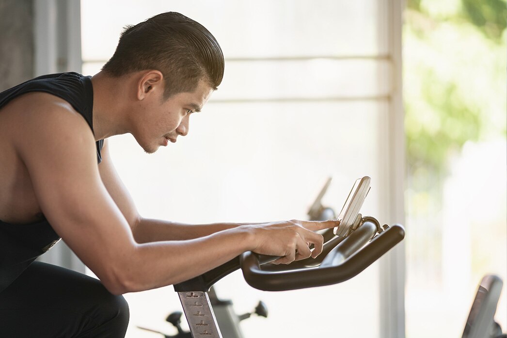 Person riding a stationary exercise bike