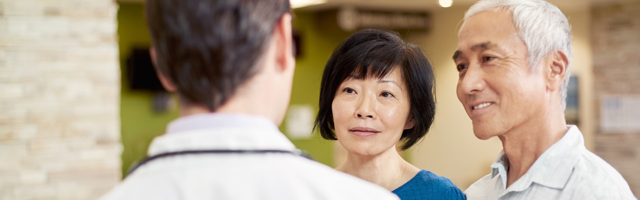 older couple look at a doctor