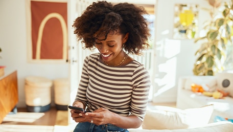 smiling-person-using-phone-at-home