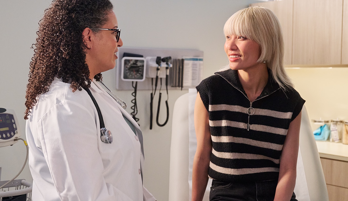 Doctor and patient speaking to each other in examination room