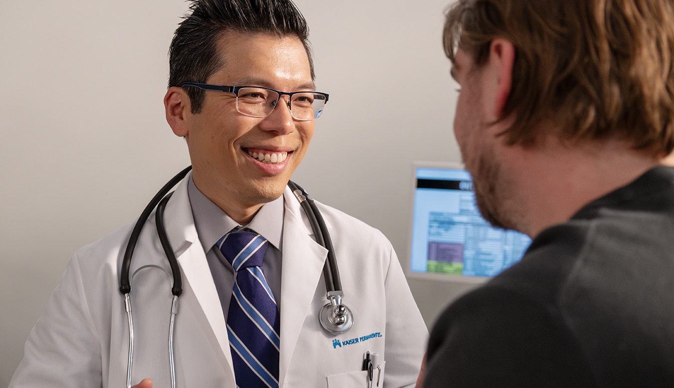 Doctor speaking to patient in examination room