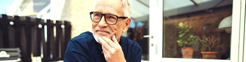 senior man in glasses smiling