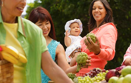 People shopping for artichokes at farmers market