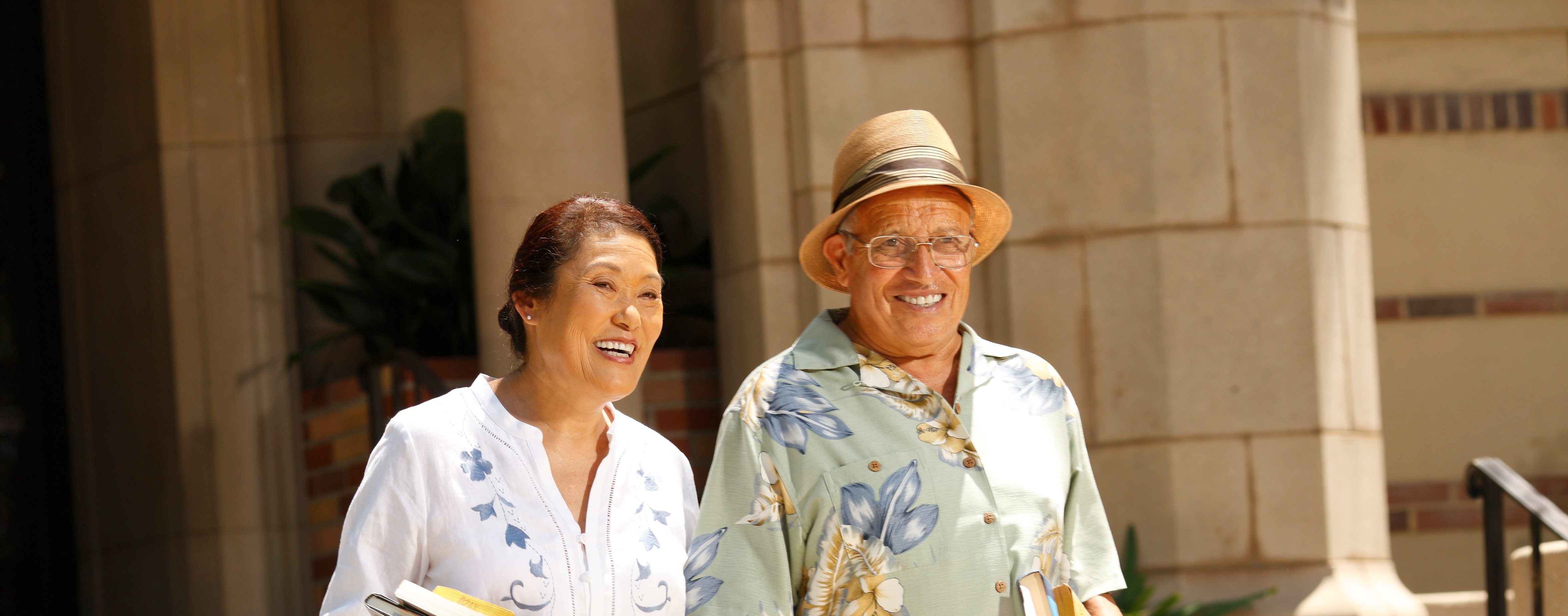 Two retired people smiling.