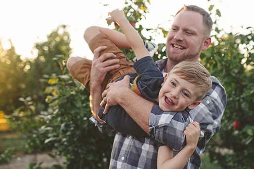 adult and child dancing and laughing together