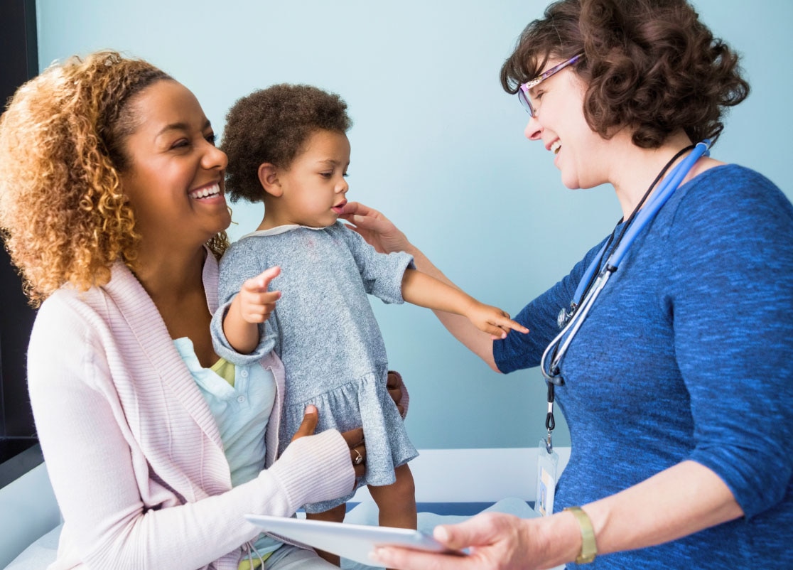 Doctor laughing with parent and child