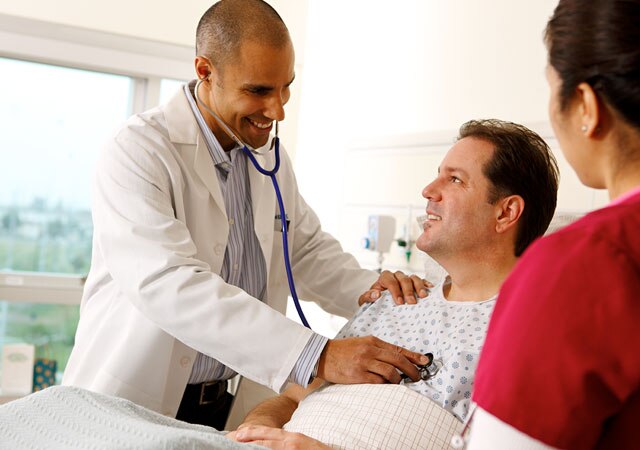 Photo of doctor examining man with stethoscope Photo of doctor examining man with stethoscope