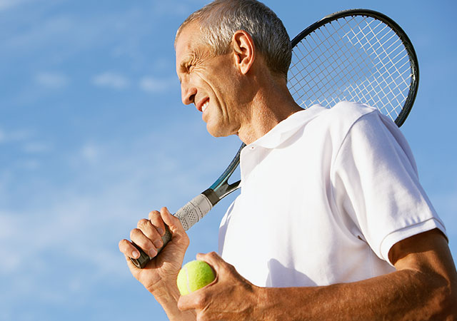 Photo of man holding tennis racket and ball Photo of man holding tennis racket and ball