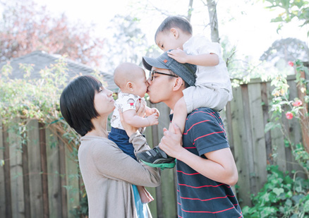 mother, father and two children in back yard