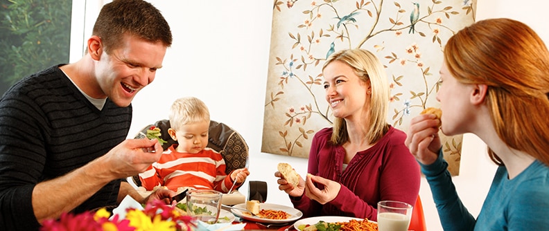 Family eating a meal and laughing