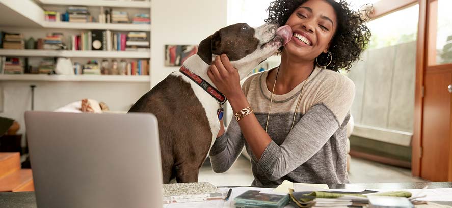 Happy woman and her dog at home