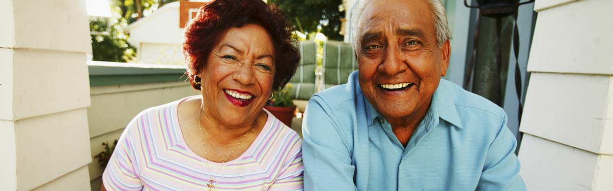 Older couple looking at the camera and laughing