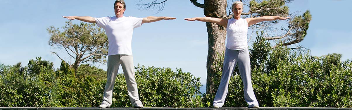 Two people with arms outstretched outside