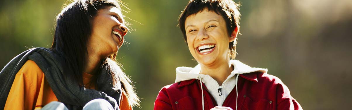 Two women lauging together outside