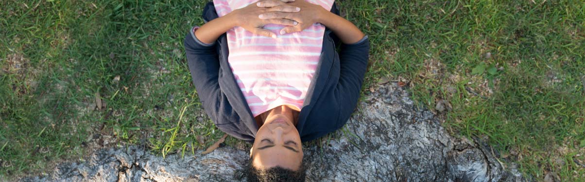 Woman laying outside looking peaceful