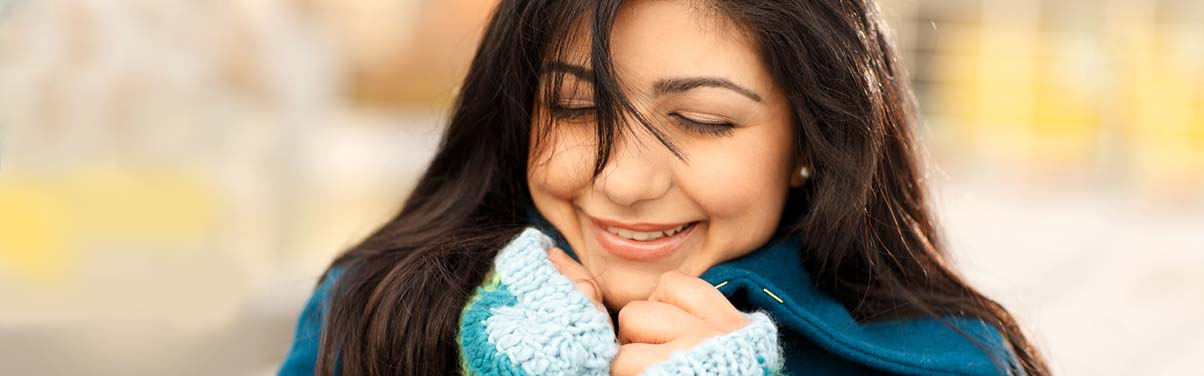 Woman smiling wearing a scarf
