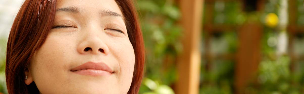 Woman smiling while meditating