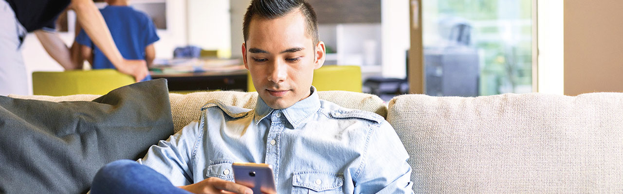 a man reviews finances on his phone