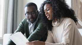 two people look at paper