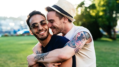 Young man kissing his boyfriend for farewell