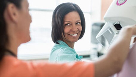 Persona que trabaja en el cuidado de la salud y paciente preparándose para una prueba de detección
