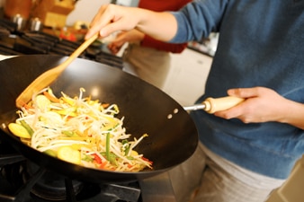 Person cooking food in a pan