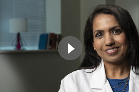 Video play button over image of Kaiser Permanente Colorado doctor smiling