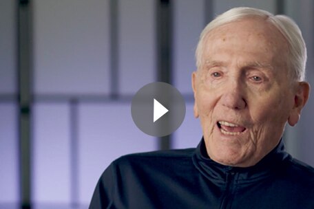 Video play button over image of Kaiser Permanente Colorado member talking