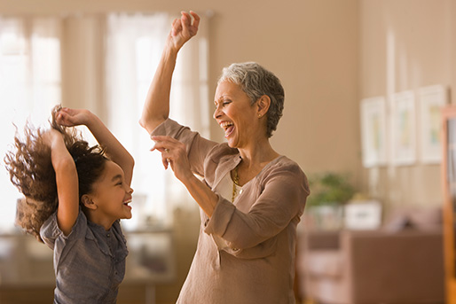 adult and child dancing and laughing together