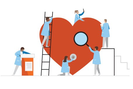 Miembros de un equipo de cuidado rodeando y examinando un gran corazón rojo 