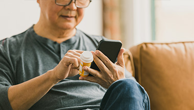 man reviews info on smartphone